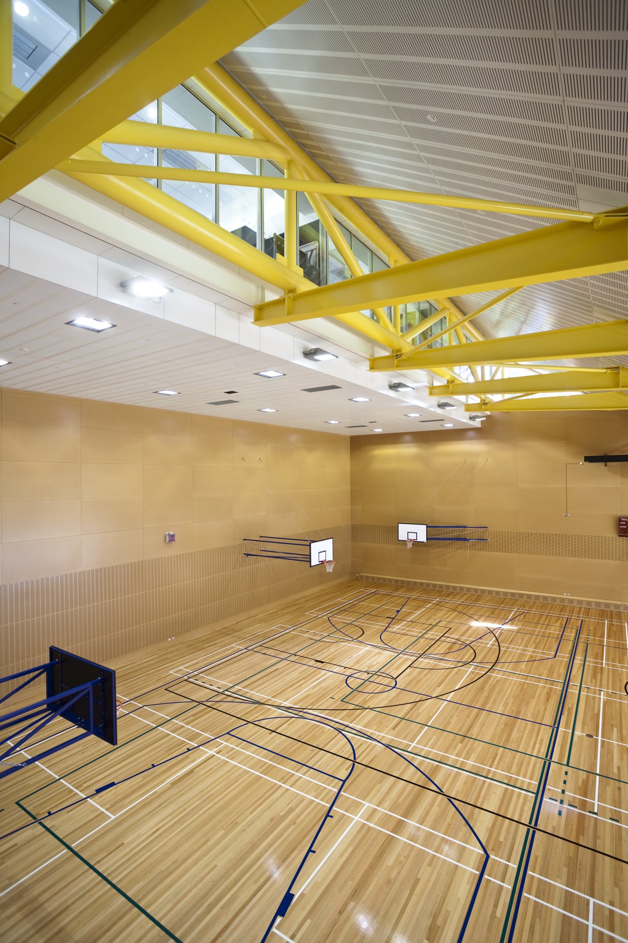 Interior view of the gymnasium of the St architecture, ceiling, daylighting, floor, flooring, interior design, leisure centre, line, sport venue, structure, wall, wood, yellow, orange