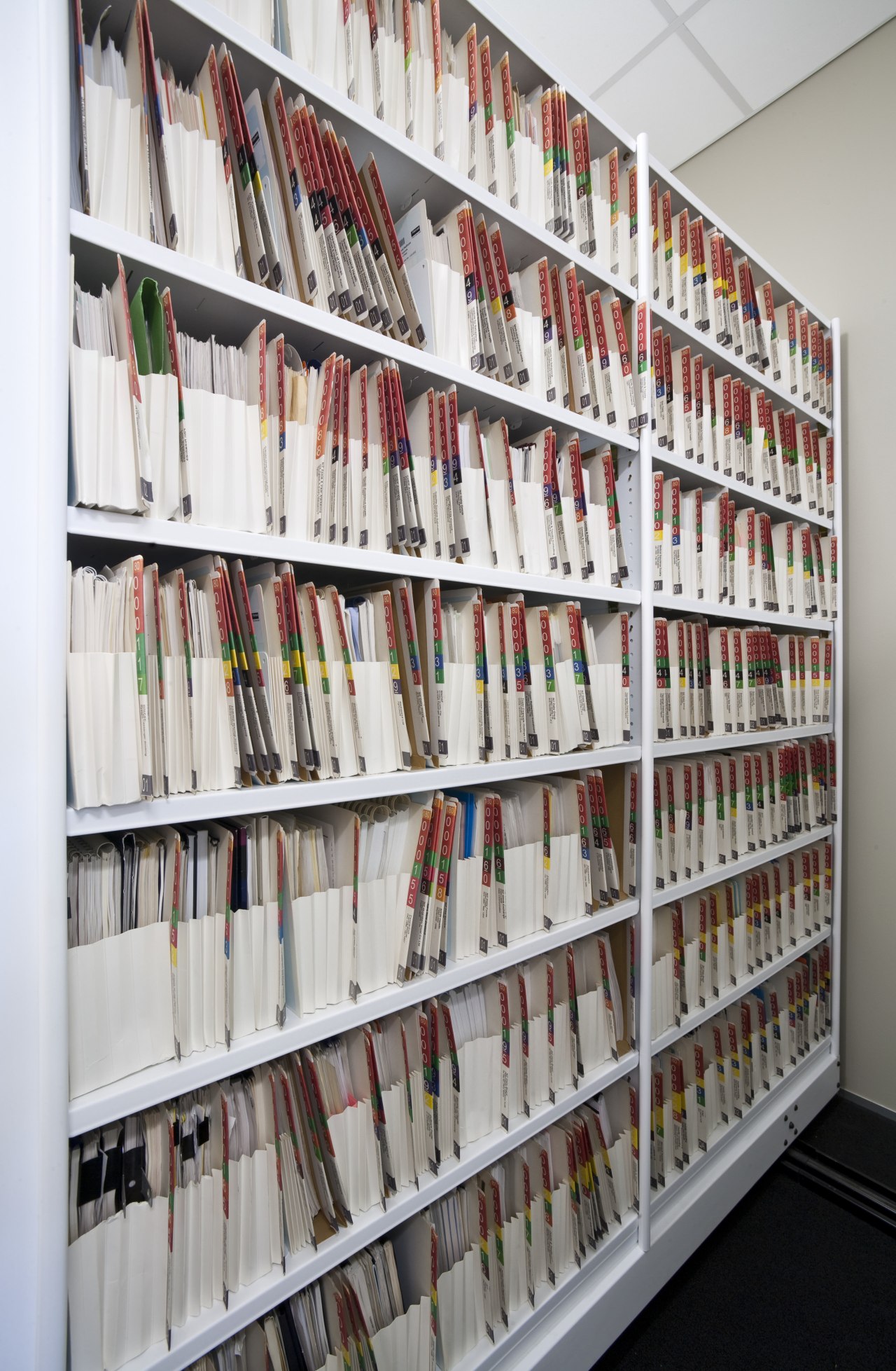 View of adjustable storage shelves with lockable handwheels. bookcase, institution, library, library science, public library, shelf, shelving, gray