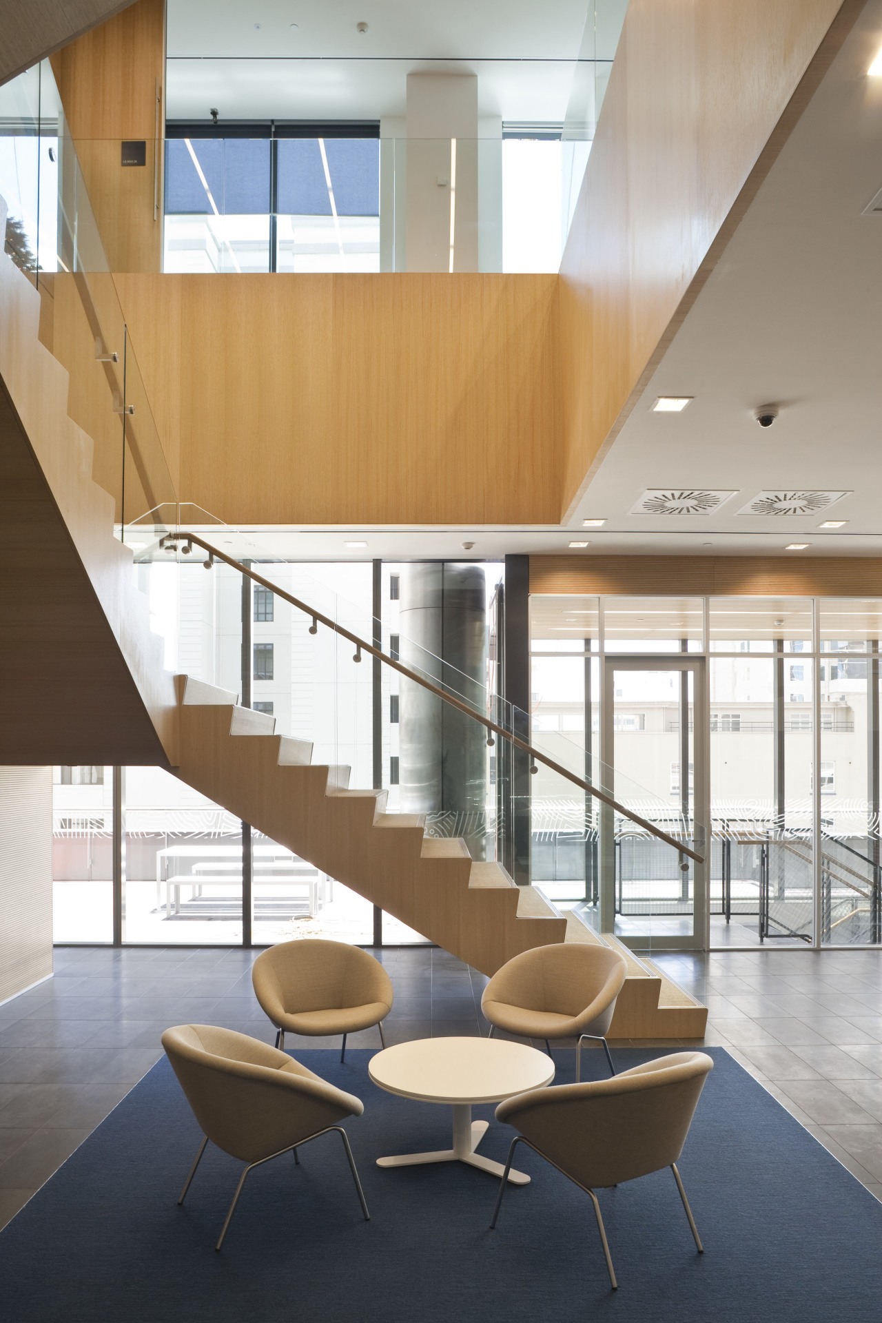 The offices of BNZ feature a combination of architecture, ceiling, daylighting, floor, furniture, glass, handrail, interior design, product design, stairs, table, white