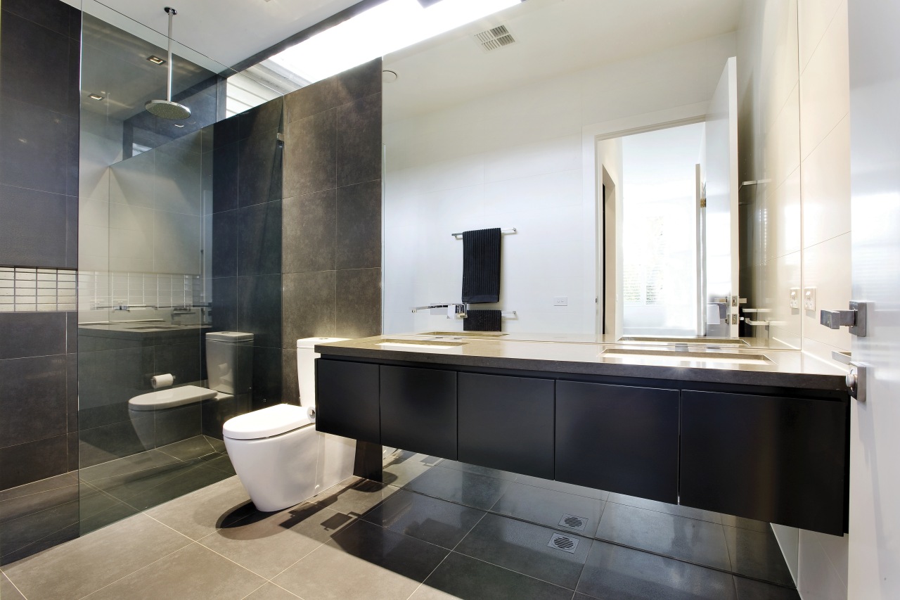 view of the ensuite bathroom which features a bathroom, countertop, floor, interior design, room, sink, white, black