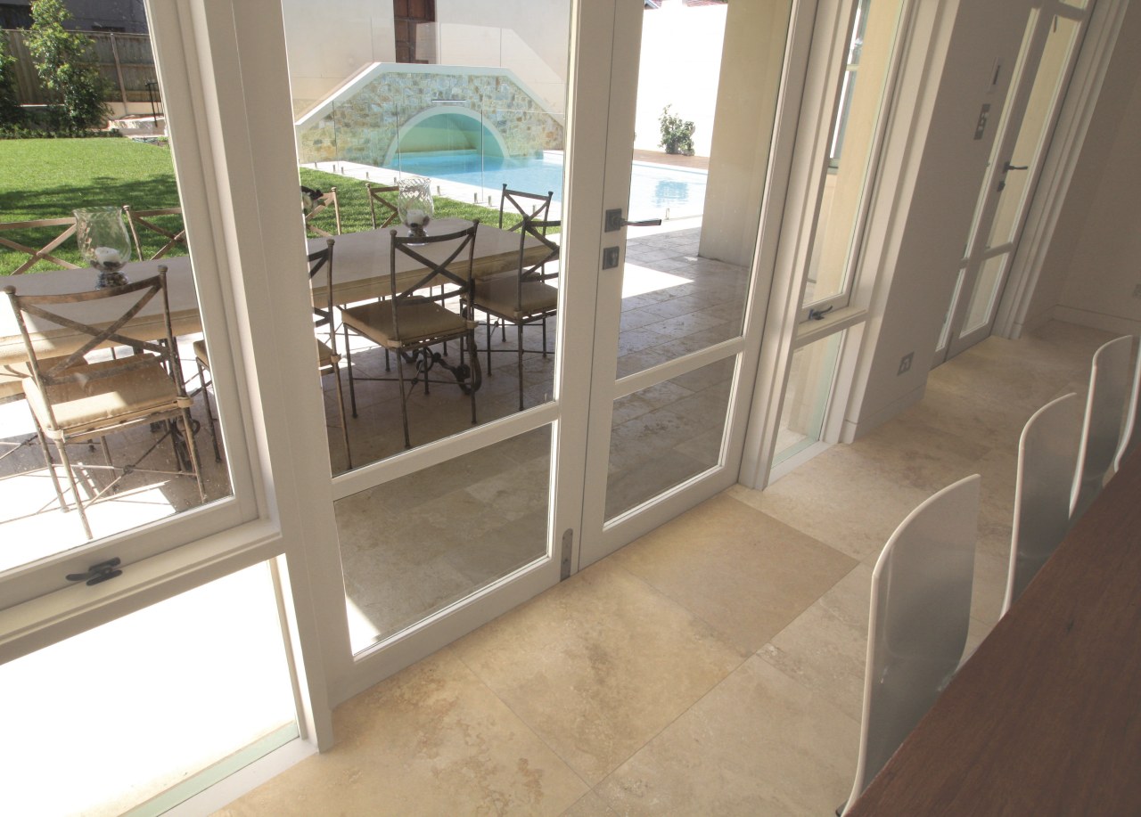 View of travertine tiled floors from SareenStone. estate, floor, flooring, glass, handrail, home, property, real estate, tile, window, brown
