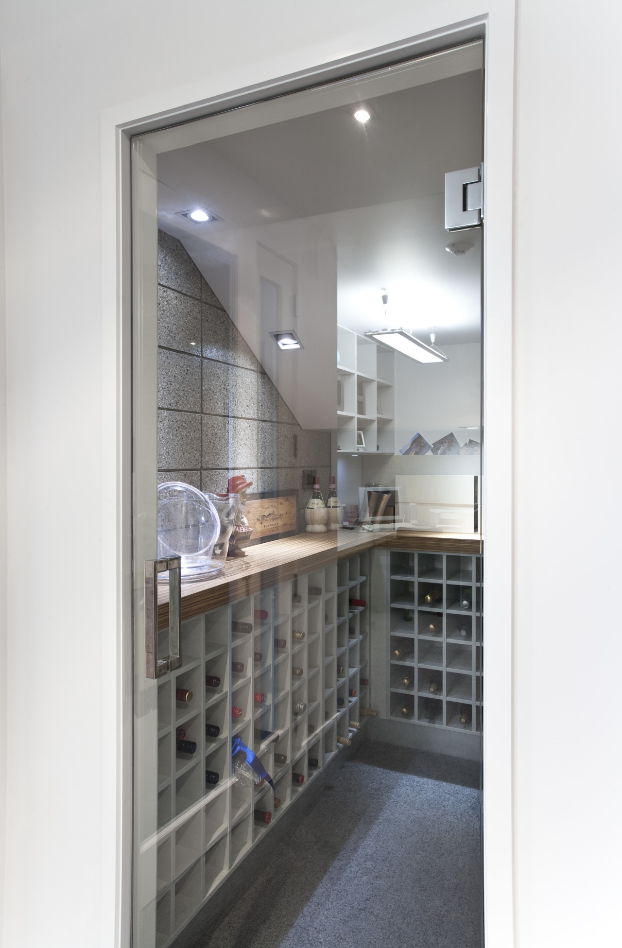 view of a wine storage area in a door, glass, shelving, white, gray