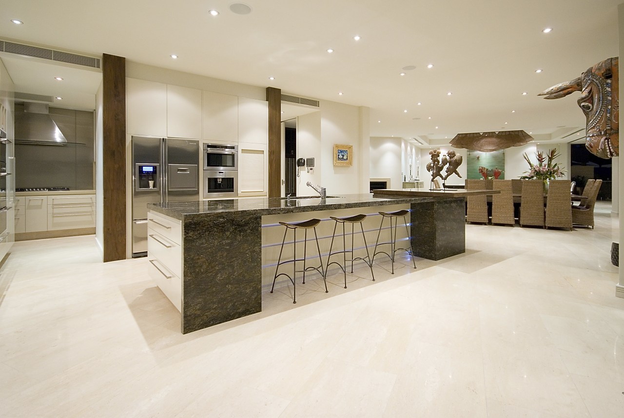 View of the kitchen area which features an cabinetry, countertop, cuisine classique, floor, flooring, interior design, kitchen, lobby, real estate, room, tile, wood flooring, white