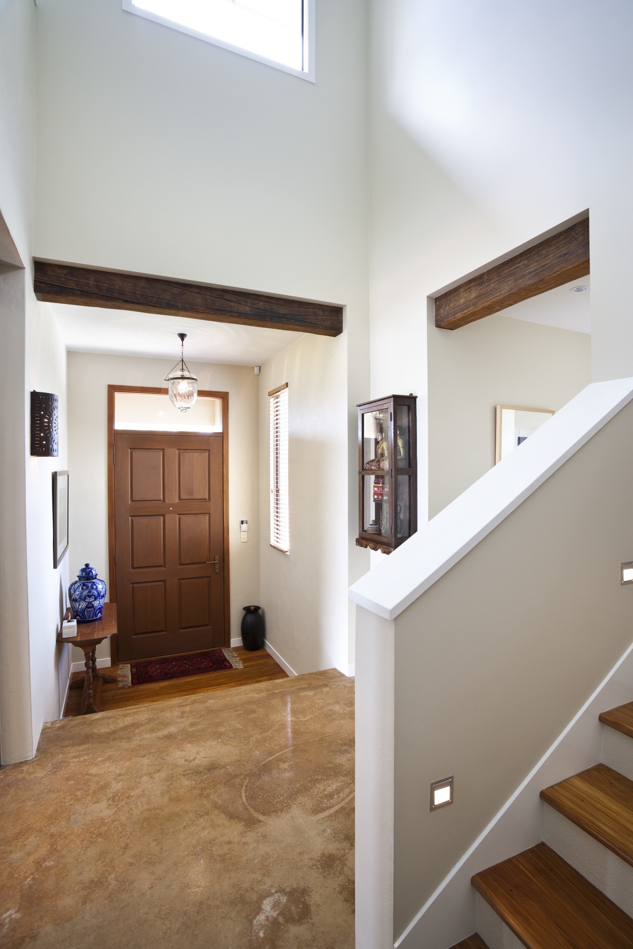 view of a double-height entrance way in a apartment, architecture, ceiling, daylighting, door, estate, floor, flooring, hardwood, home, house, interior design, property, real estate, room, stairs, wall, window, wood, wood flooring, white, gray