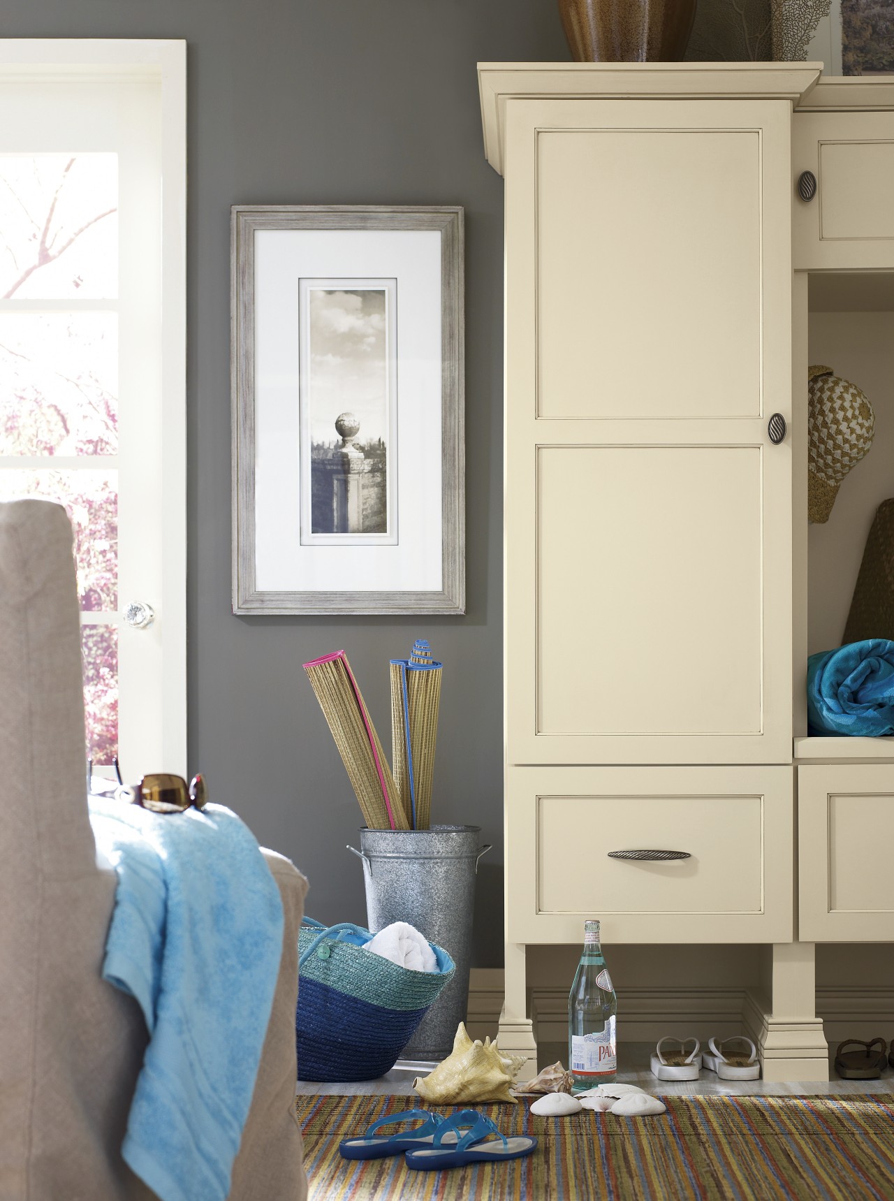 View of a bedroom which features cabinetry from cabinetry, chest of drawers, door, furniture, home, interior design, living room, paint, room, shelf, shelving, table, wall, window, white