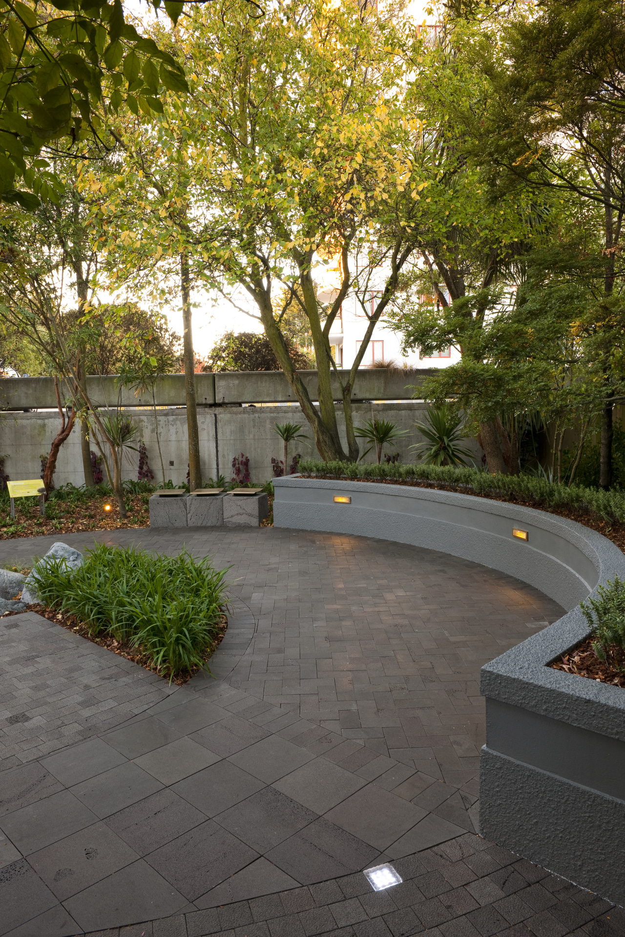 View of private courtyard which features native planting, architecture, backyard, courtyard, estate, garden, grass, landscape, landscaping, leaf, outdoor structure, patio, plant, real estate, residential area, road surface, tree, walkway, wall, yard, brown, gray