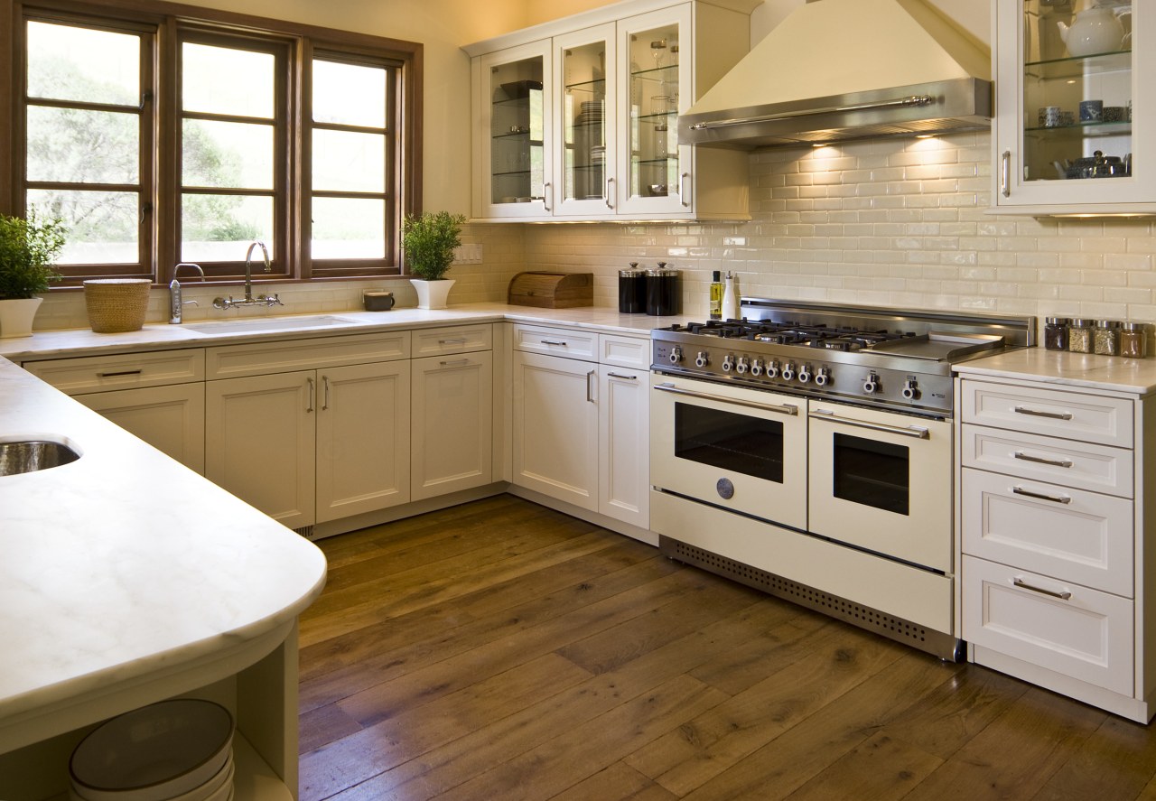 View of a traditional-styled kitchen which features stainless cabinetry, countertop, cuisine classique, floor, flooring, hardwood, interior design, kitchen, laminate flooring, room, wood flooring, brown