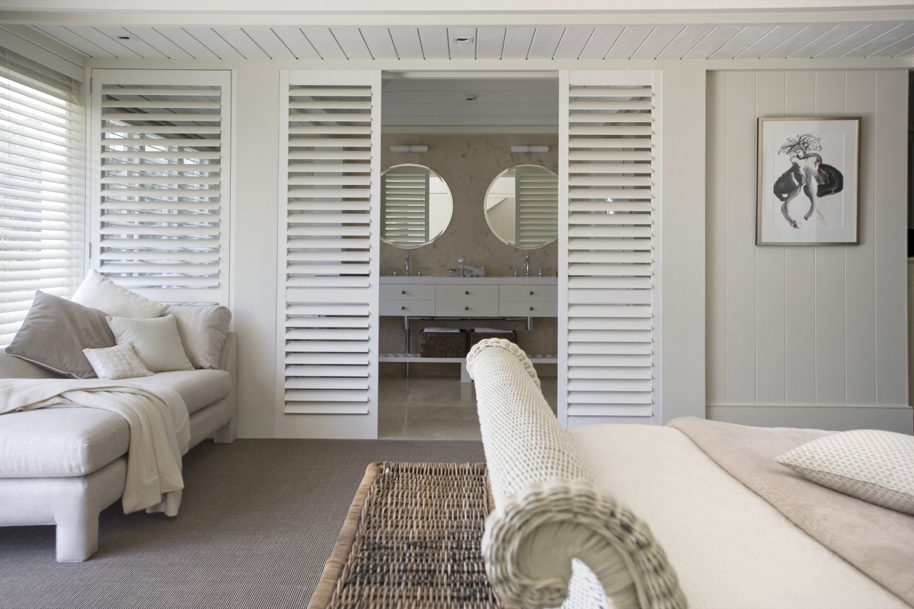 Interior view of a light-toned beach house. floor, furniture, home, interior design, living room, room, window, window covering, wood, gray