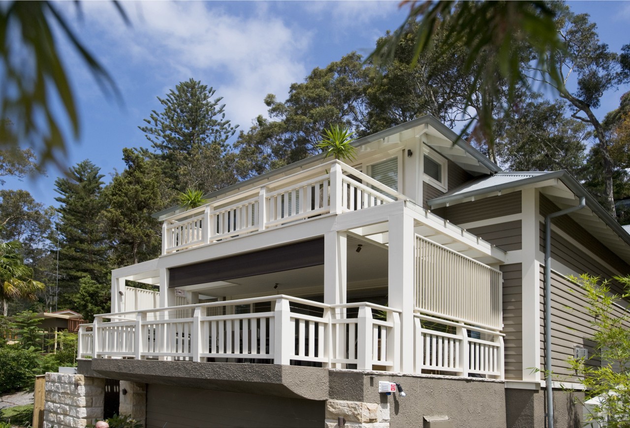 Exterior view of this traditional beach house by building, cottage, estate, facade, historic house, home, house, outdoor structure, property, real estate, siding, gray