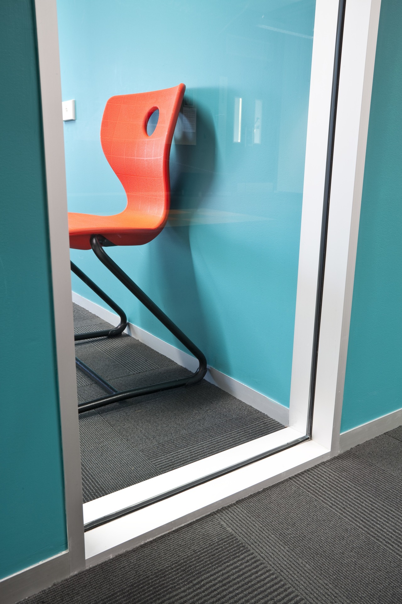 Close-up view of this office entrance way blue, chair, floor, flooring, furniture, glass, line, product, product design, teal