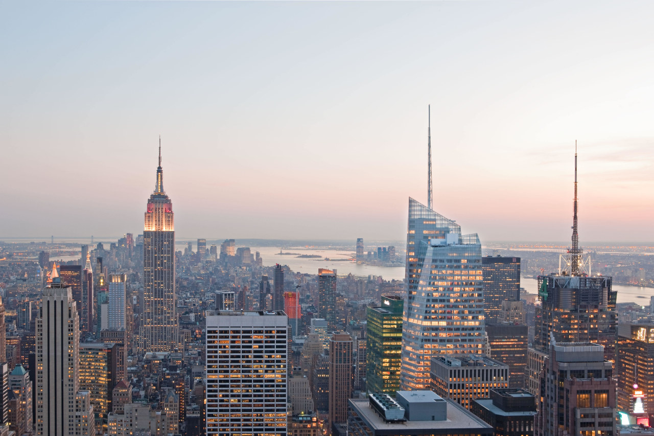 View of the Bank of America Tower in building, city, cityscape, dawn, daytime, downtown, dusk, evening, horizon, landmark, metropolis, metropolitan area, morning, sky, skyline, skyscraper, sunset, tower, tower block, urban area, white