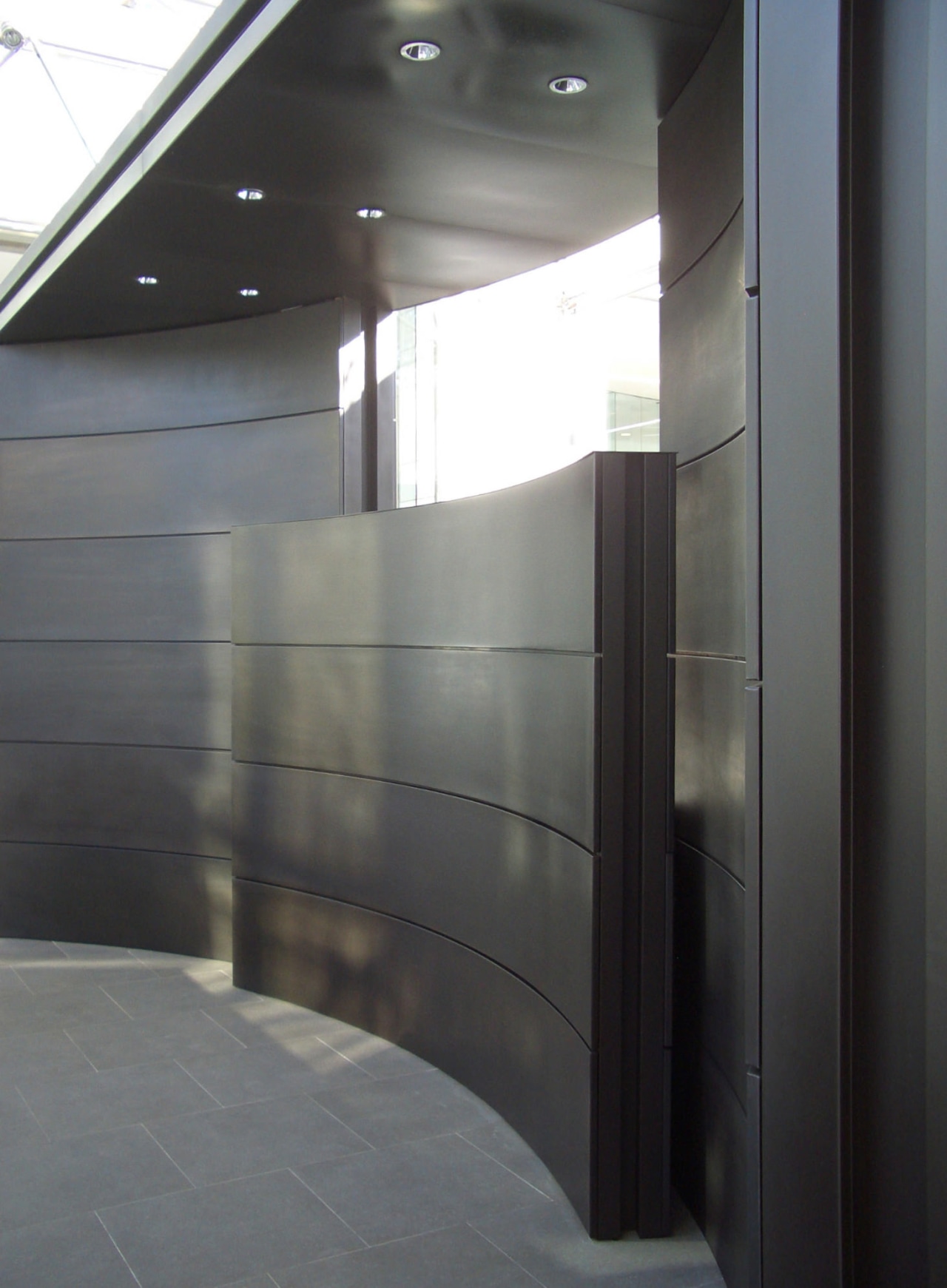 View of brass walls fabricated by Craft Metals architecture, daylighting, glass, gray, black