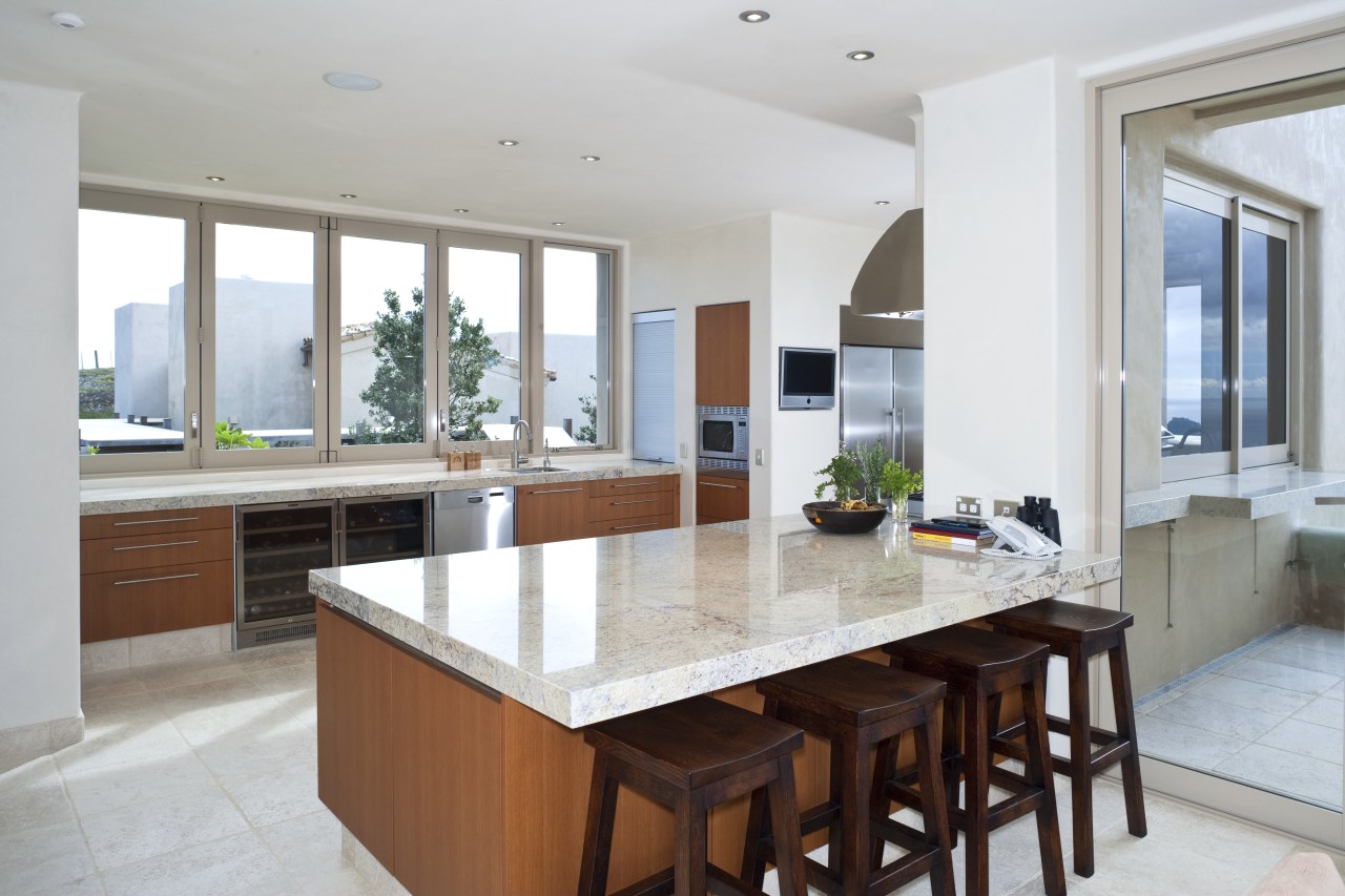 View of kitchen which features island, bar stools, cabinetry, countertop, cuisine classique, estate, interior design, kitchen, property, real estate, gray, white