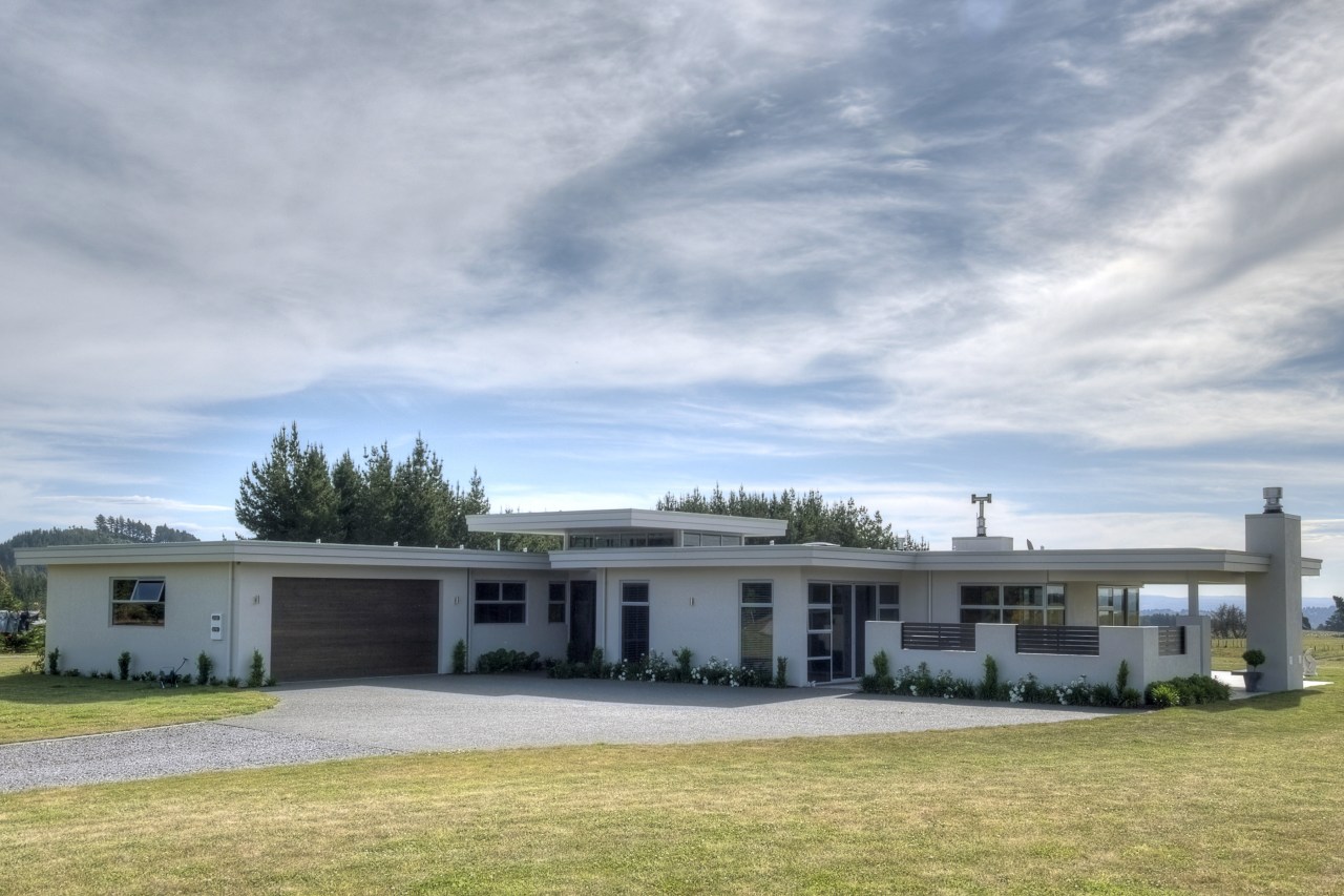 View of a house clad in Rockcote plaster. cloud, cottage, elevation, estate, farmhouse, home, house, landscape, property, real estate, roof, sky, gray