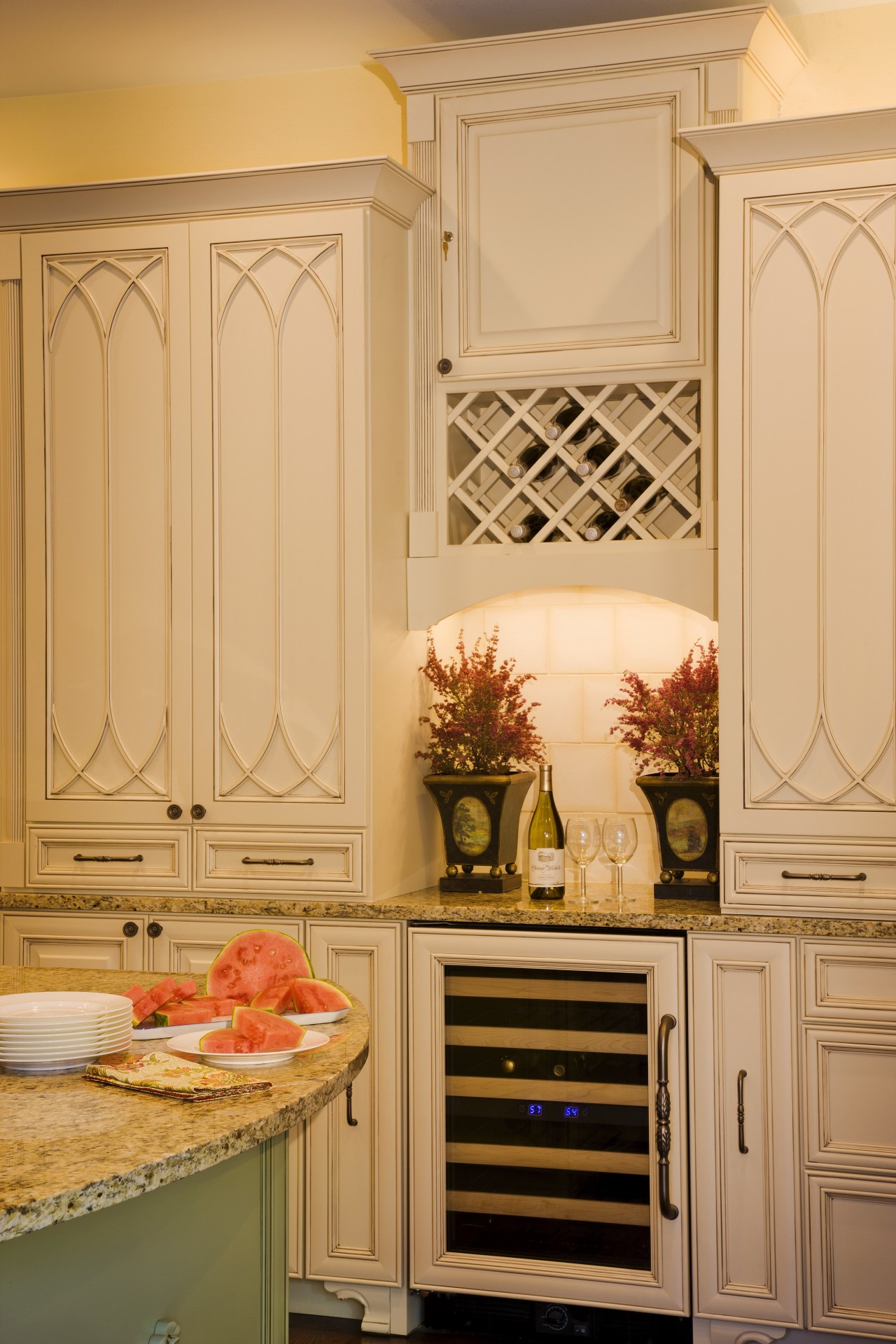 View of a kitchen and dining area with cabinetry, countertop, furniture, home, interior design, kitchen, room, orange