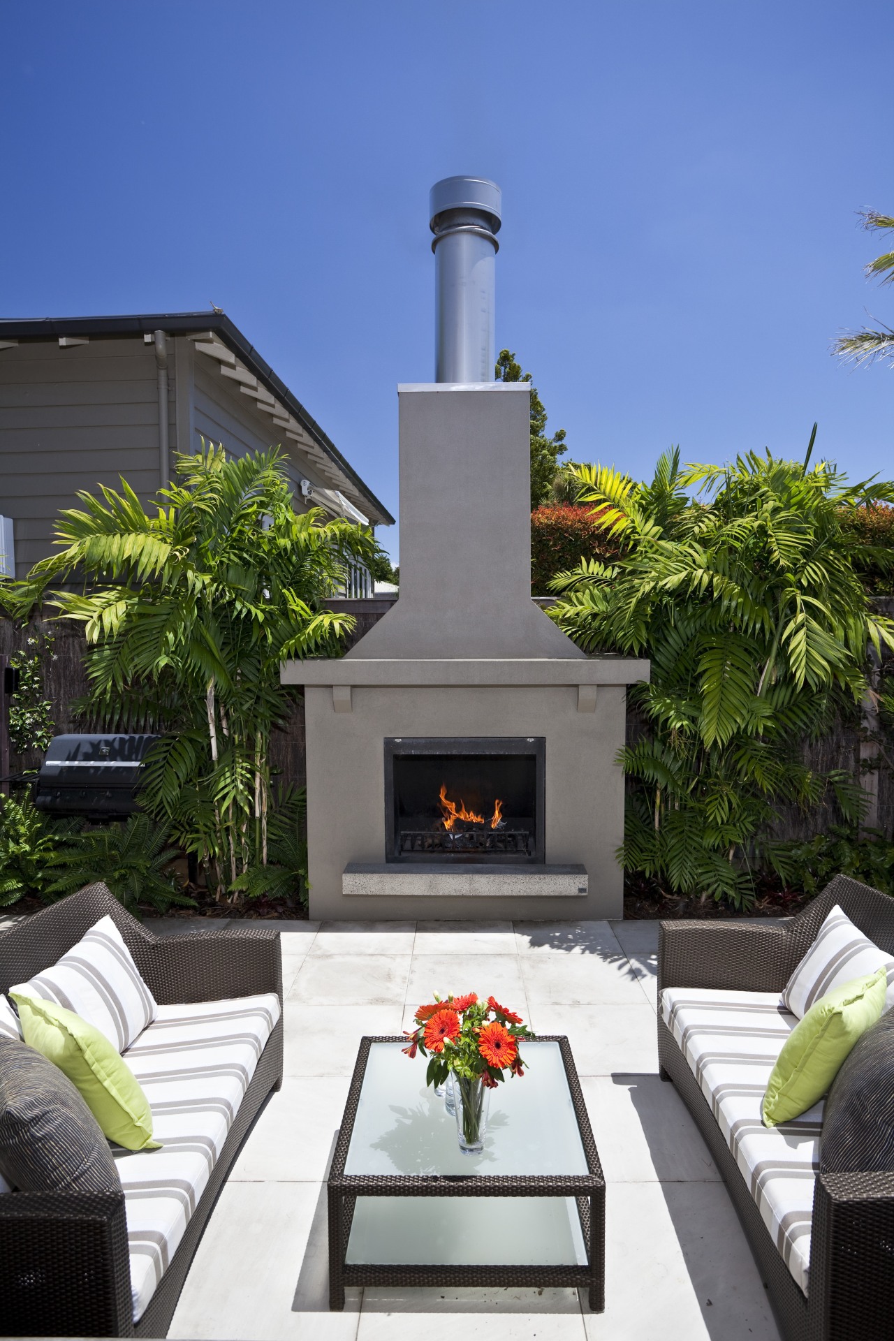 View of outdoor entertainment area, with pool, spa, home, outdoor structure, patio, real estate, blue