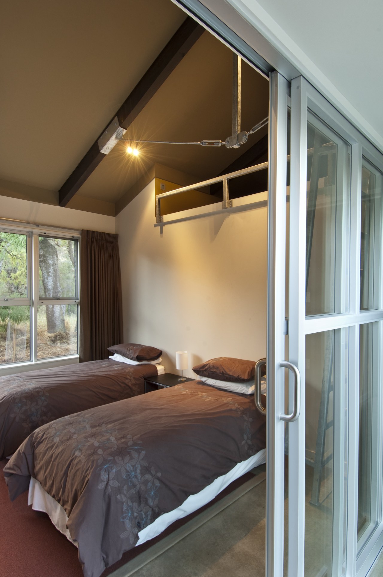 View of rural home with open plan lounge architecture, bed frame, bedroom, ceiling, door, home, house, interior design, real estate, room, wall, window, gray, brown