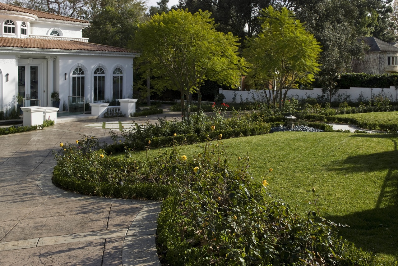 Exterior view of the Tran Residence which features estate, flora, flower, garden, grass, home, house, landscape, landscaping, lawn, park, plant, real estate, shrub, tree, walkway, yard, brown