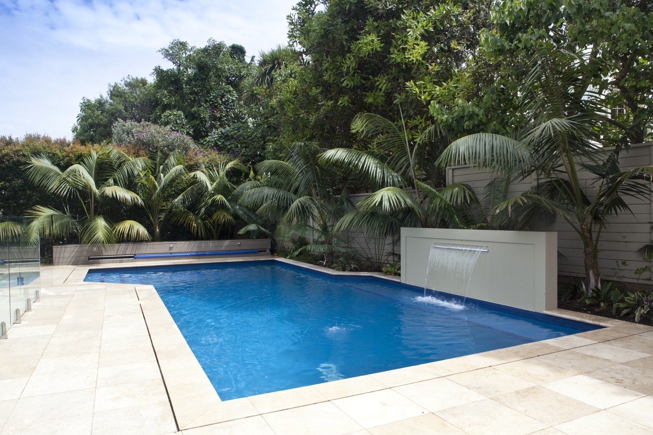 View of outdoor area with pool, paving, fountain, arecales, backyard, estate, house, leisure, palm tree, property, real estate, resort, swimming pool, villa, water, white