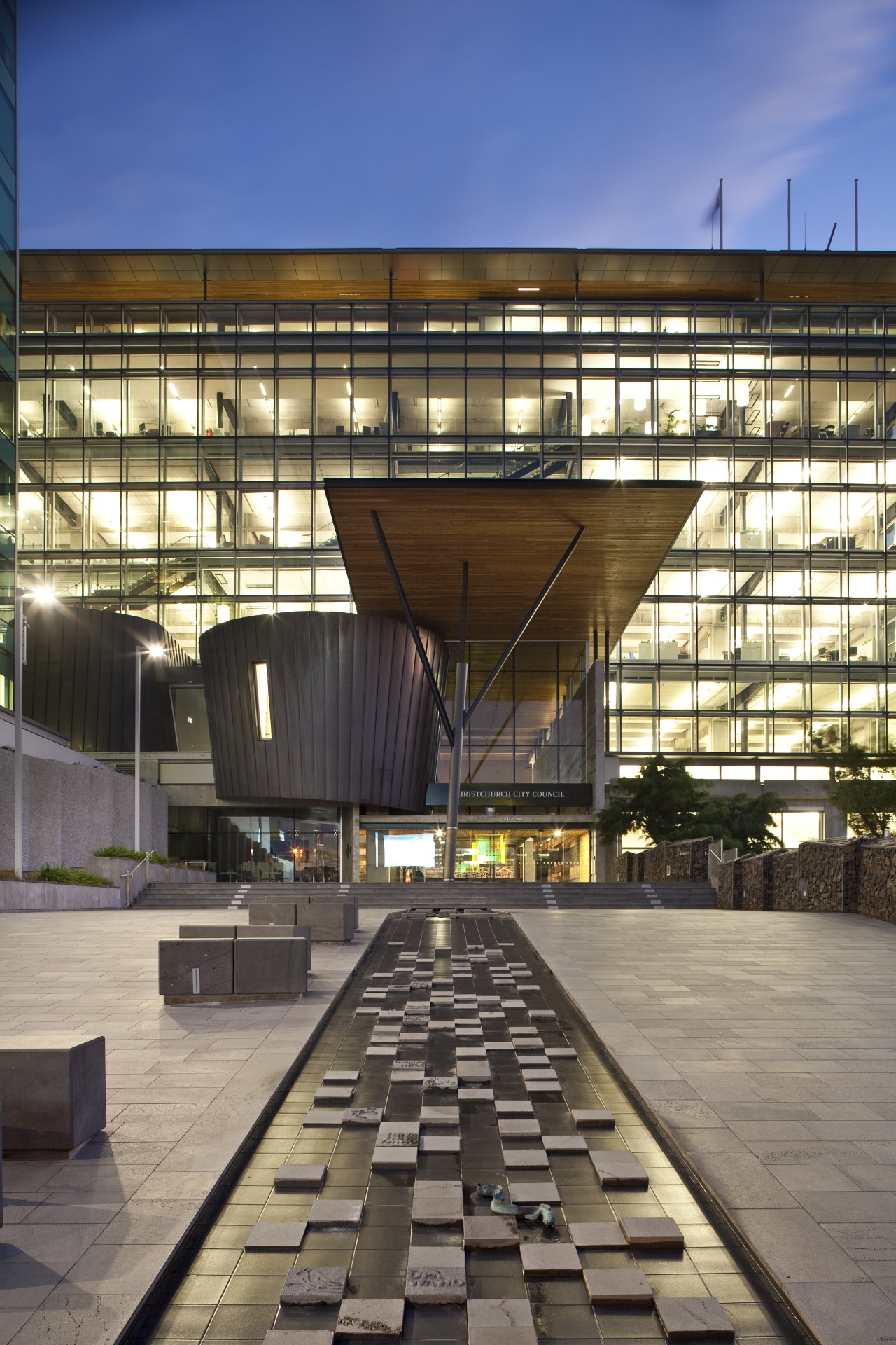 Exterior night shot of the Christchurch City Council apartment, architecture, building, condominium, corporate headquarters, daylighting, facade, headquarters, mixed use, reflection, residential area, sky, urban area, gray, black