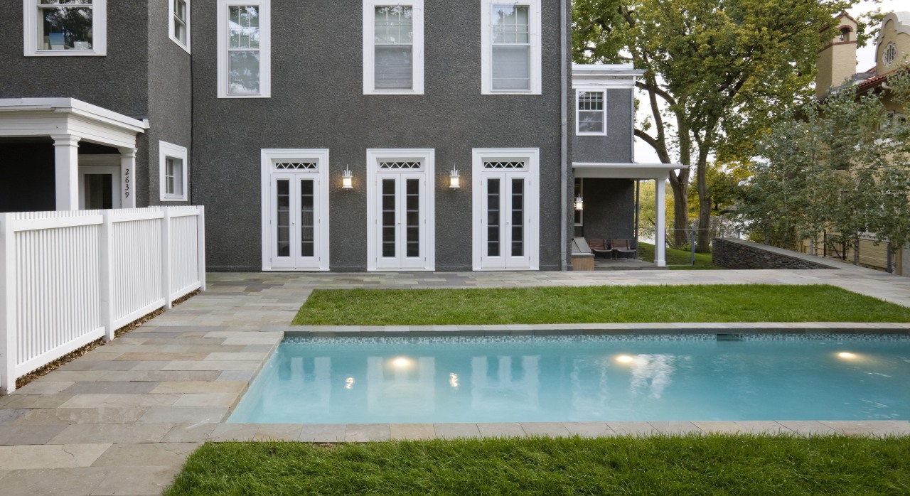 View of a multi-storey grey house with swimming architecture, backyard, courtyard, estate, facade, home, house, outdoor structure, property, real estate, residential area, swimming pool, window, yard, gray