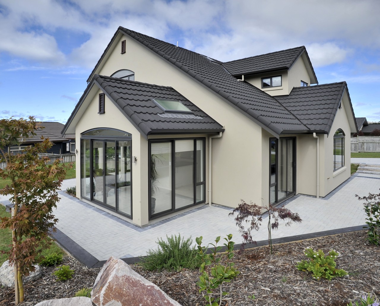 View of a David Reid Homes house with cottage, elevation, estate, facade, home, house, property, real estate, roof, siding, window, gray