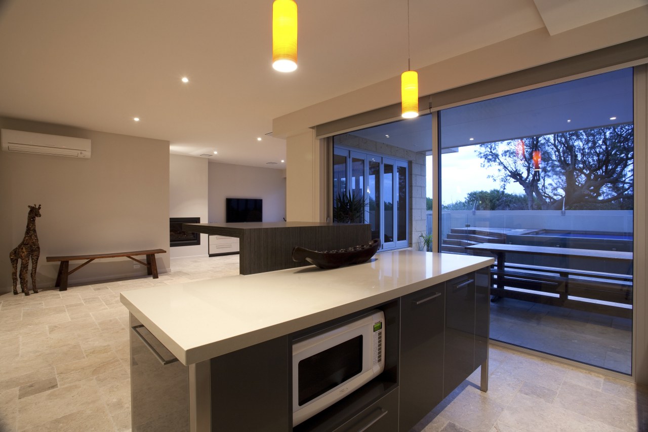 View of contemporary home with dark cabinetry, wooden interior design, real estate, brown