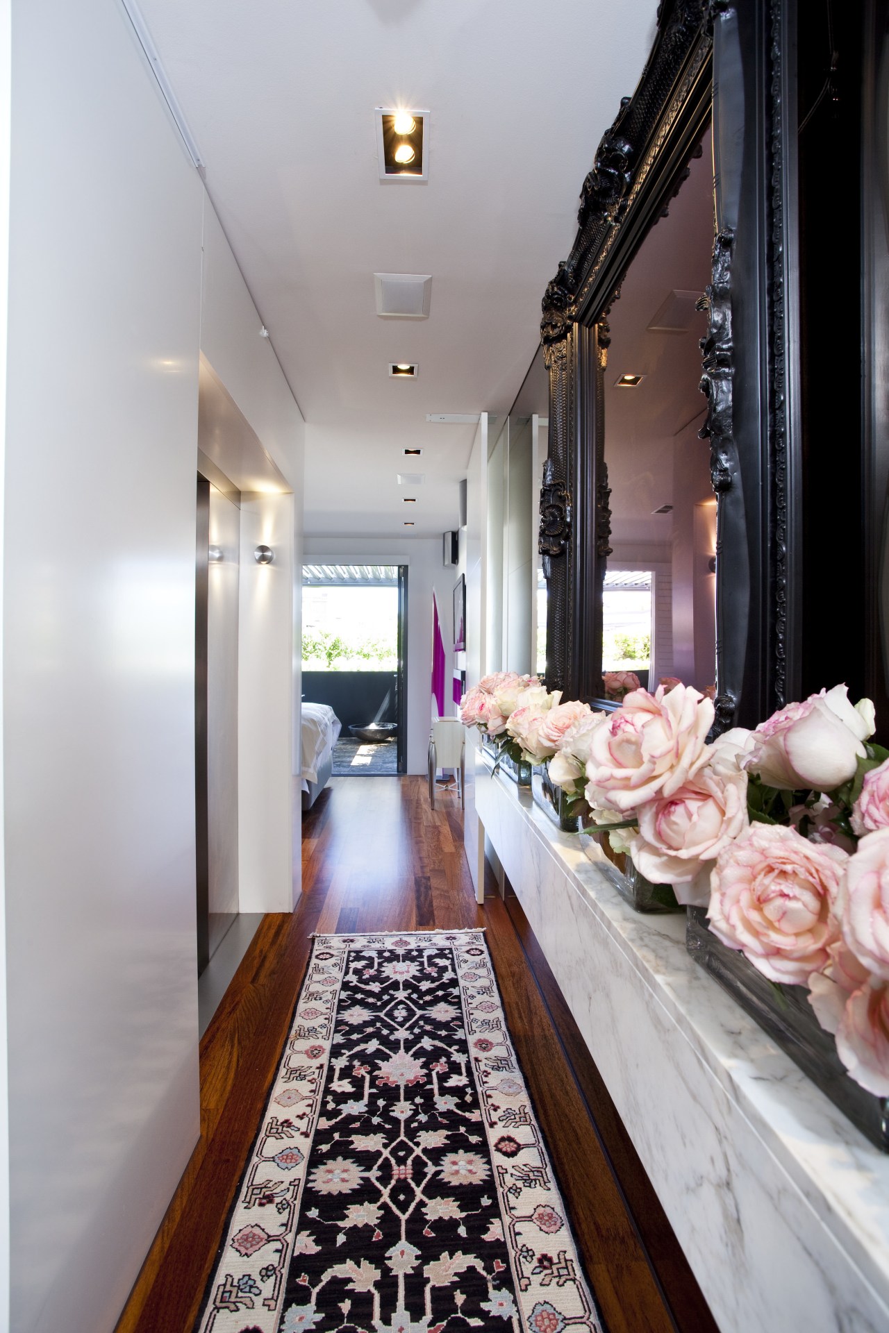 View of hallway with rug and flowers in aisle, ceiling, floor, flooring, interior design, room, gray