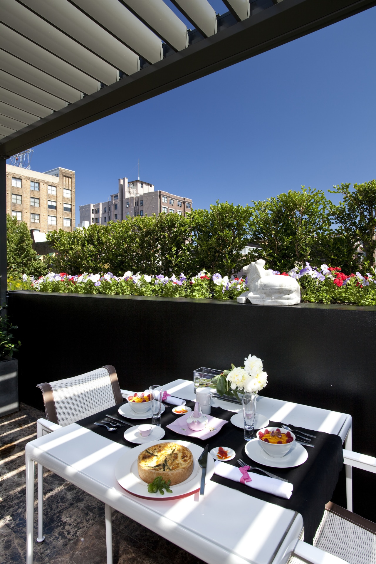 View of outdoor table laid with plates and table, black