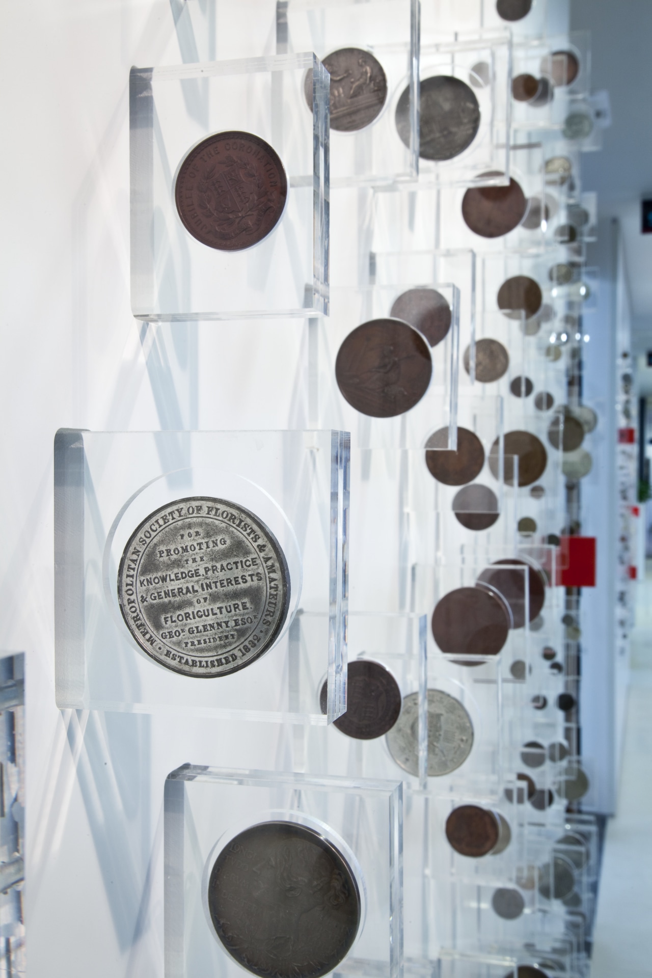 A heritage coin collection is encased in custom-designed product, product design, white