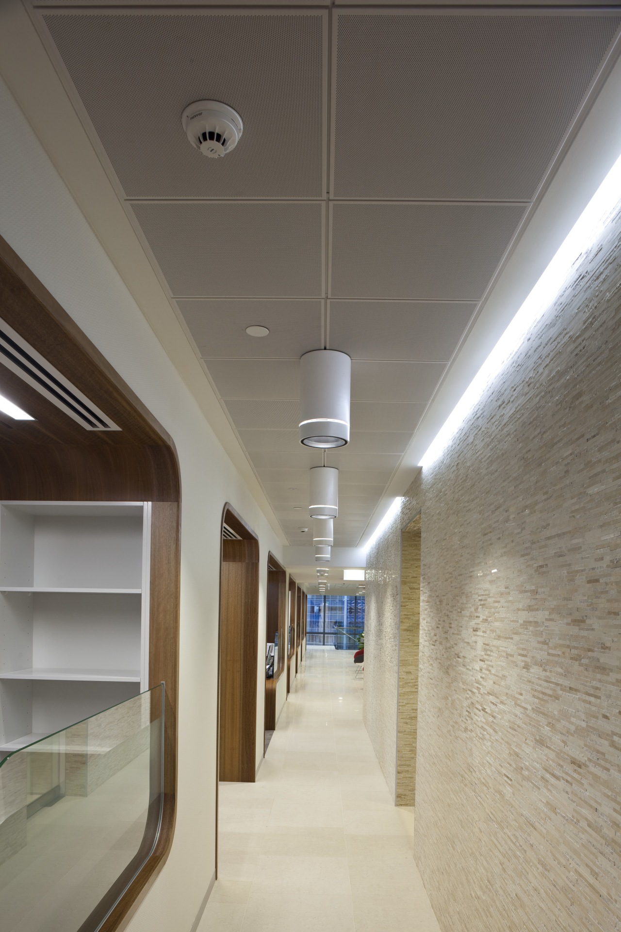 View of light-toned hallway with hanging lamps. architecture, ceiling, daylighting, interior design, lighting, gray