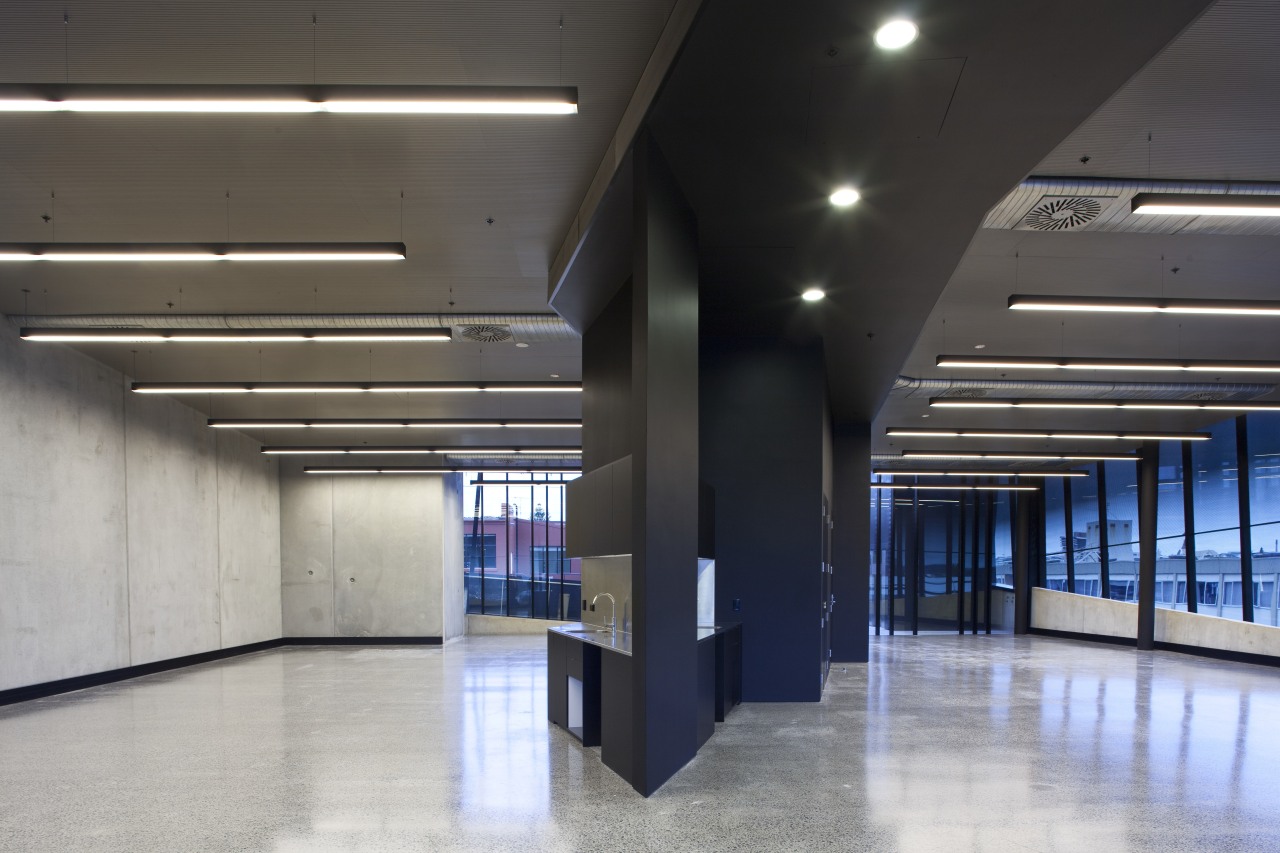 View of the Anvil Building, with angled custom architecture, ceiling, daylighting, floor, interior design, lobby, gray, black