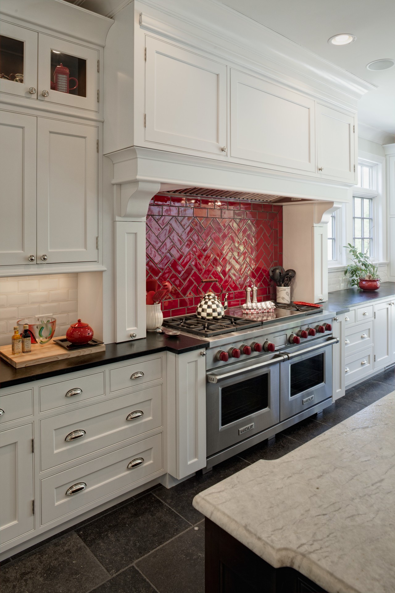 Arched openings. Red splash back. Limestone floors. White cabinetry, countertop, cuisine classique, floor, flooring, home, home appliance, interior design, kitchen, kitchen appliance, kitchen stove, room, tile, gray