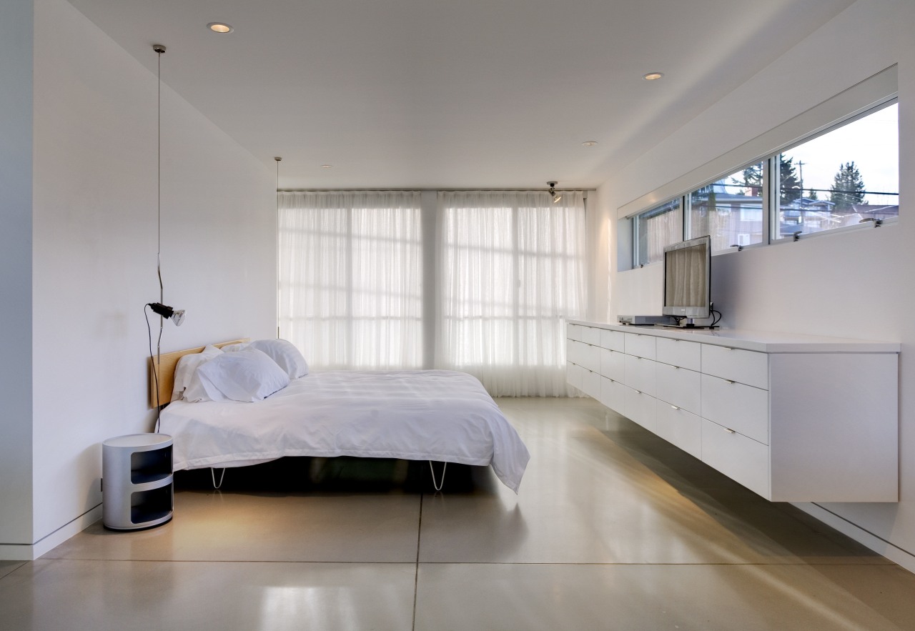 View of bedroom with white bedding and drawers. architecture, bed frame, bedroom, ceiling, floor, interior design, room, wall, gray