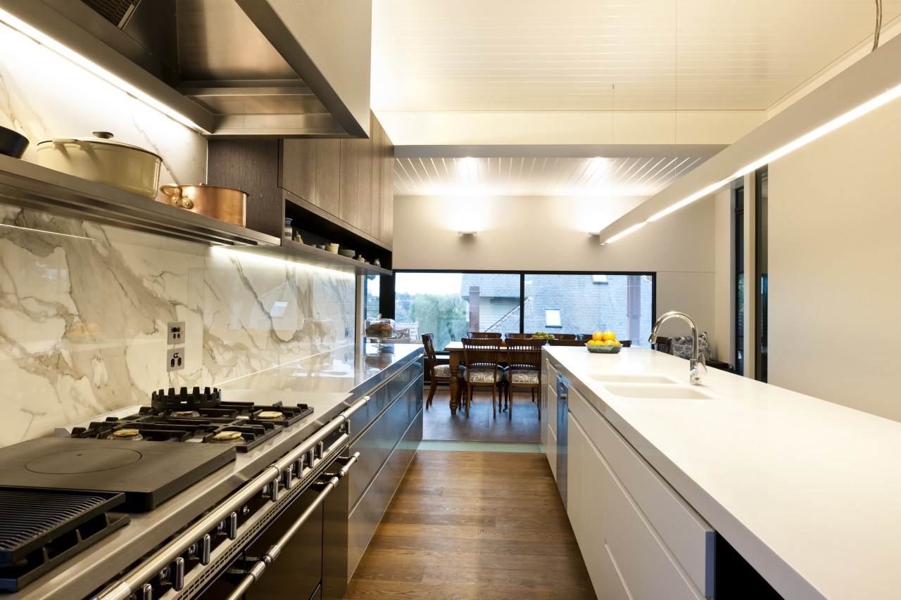 Stainless steel appliances. Minimalistic design. Indoor- outdoor flow. countertop, interior design, kitchen, white, orange