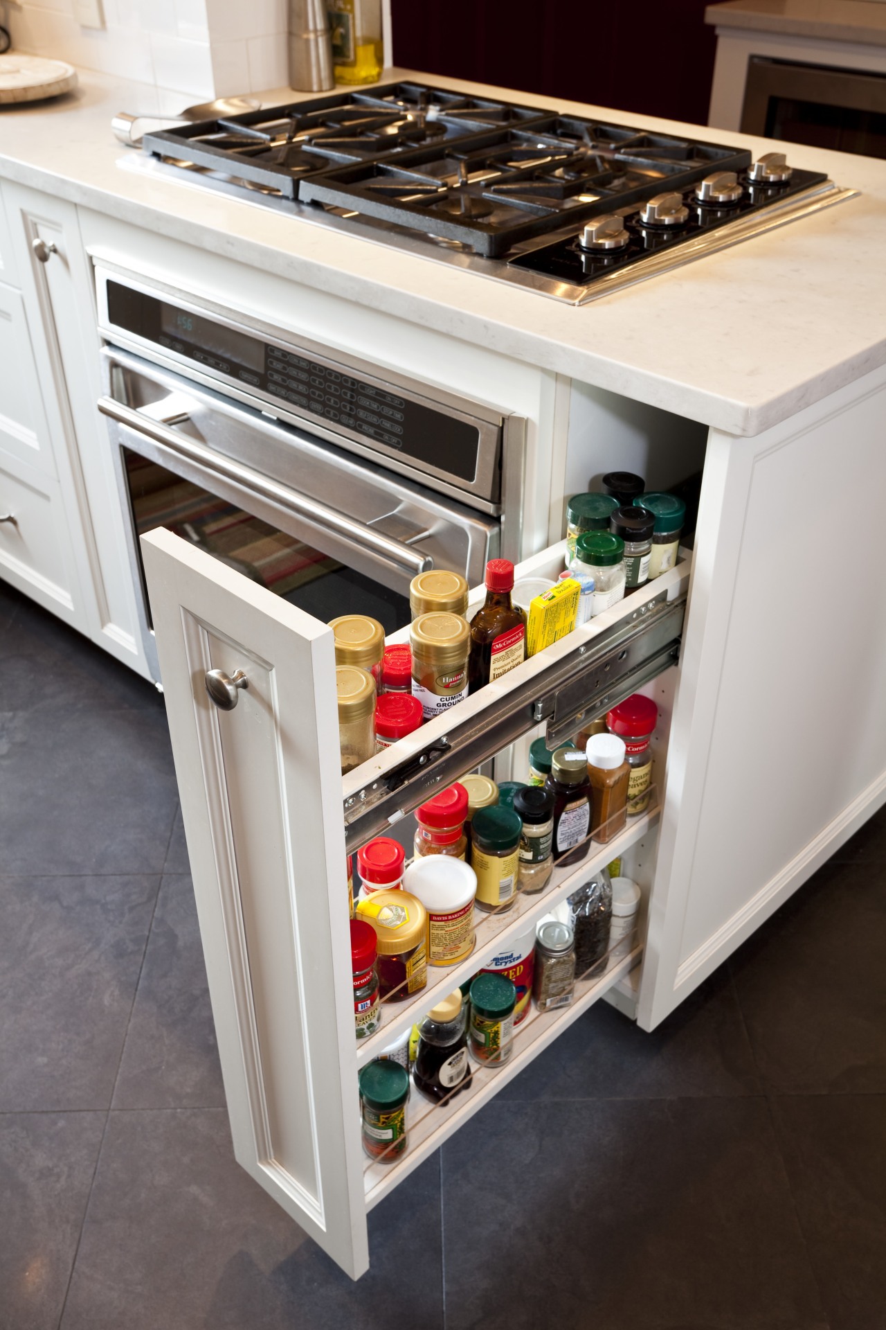Black porcelain floor tiles. Red accenting walls. Carra countertop, drawer, furniture, kitchen, shelf, gray