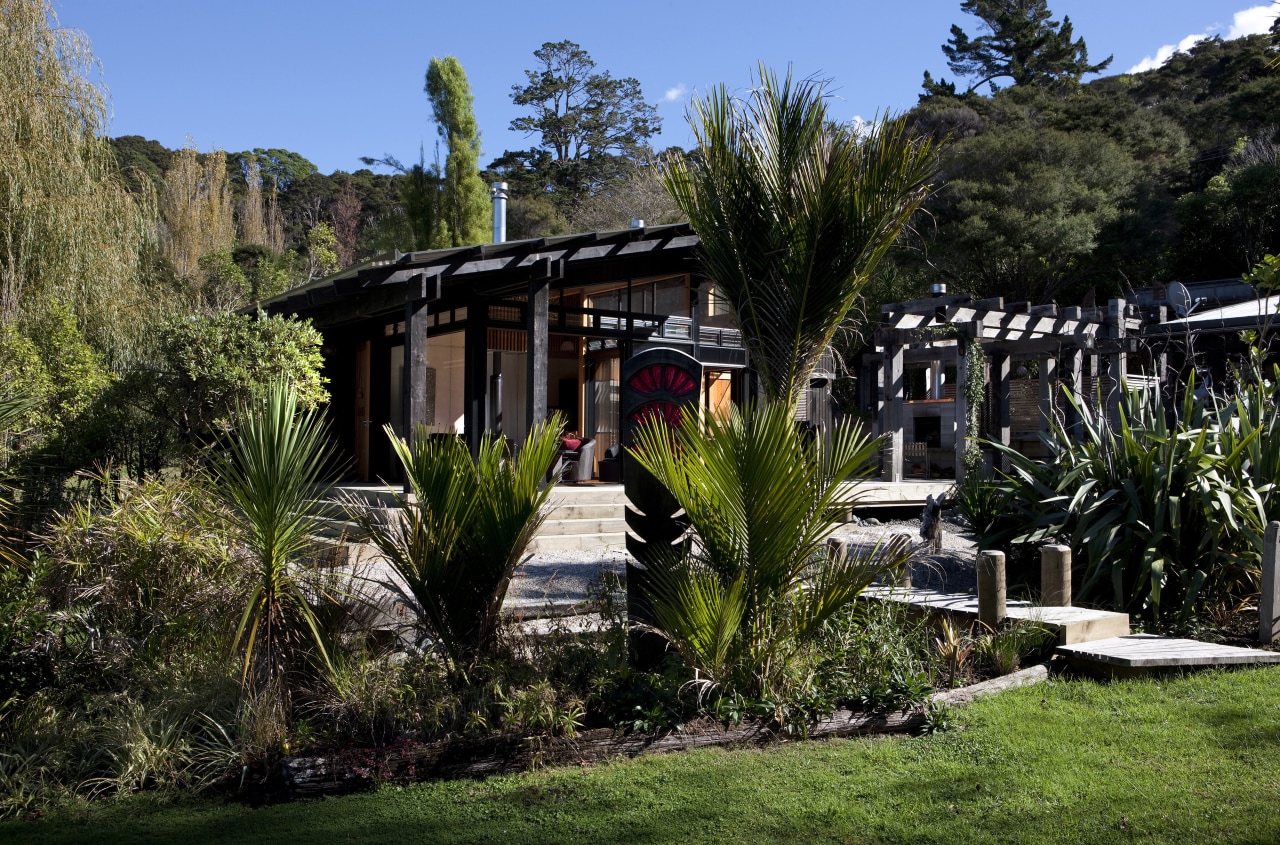 The timber for this house is treated with cottage, estate, grass, home, house, landscape, plant, real estate, tree, villa, black, brown