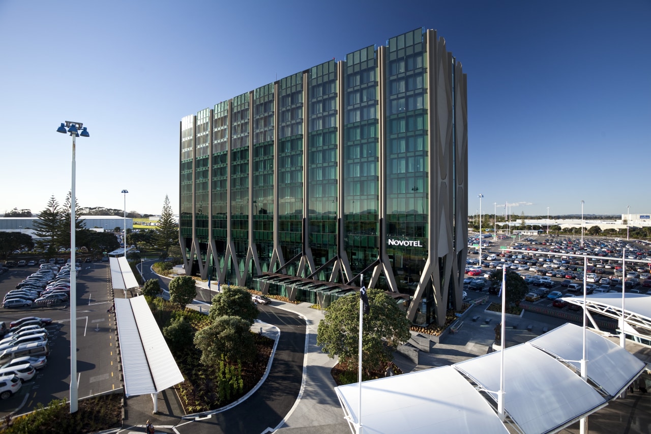 Novotel Hotel, Auckland Airport. The handles on doors architecture, building, city, condominium, corporate headquarters, daytime, headquarters, metropolitan area, mixed use, reflection, sky, structure, urban area, water, teal