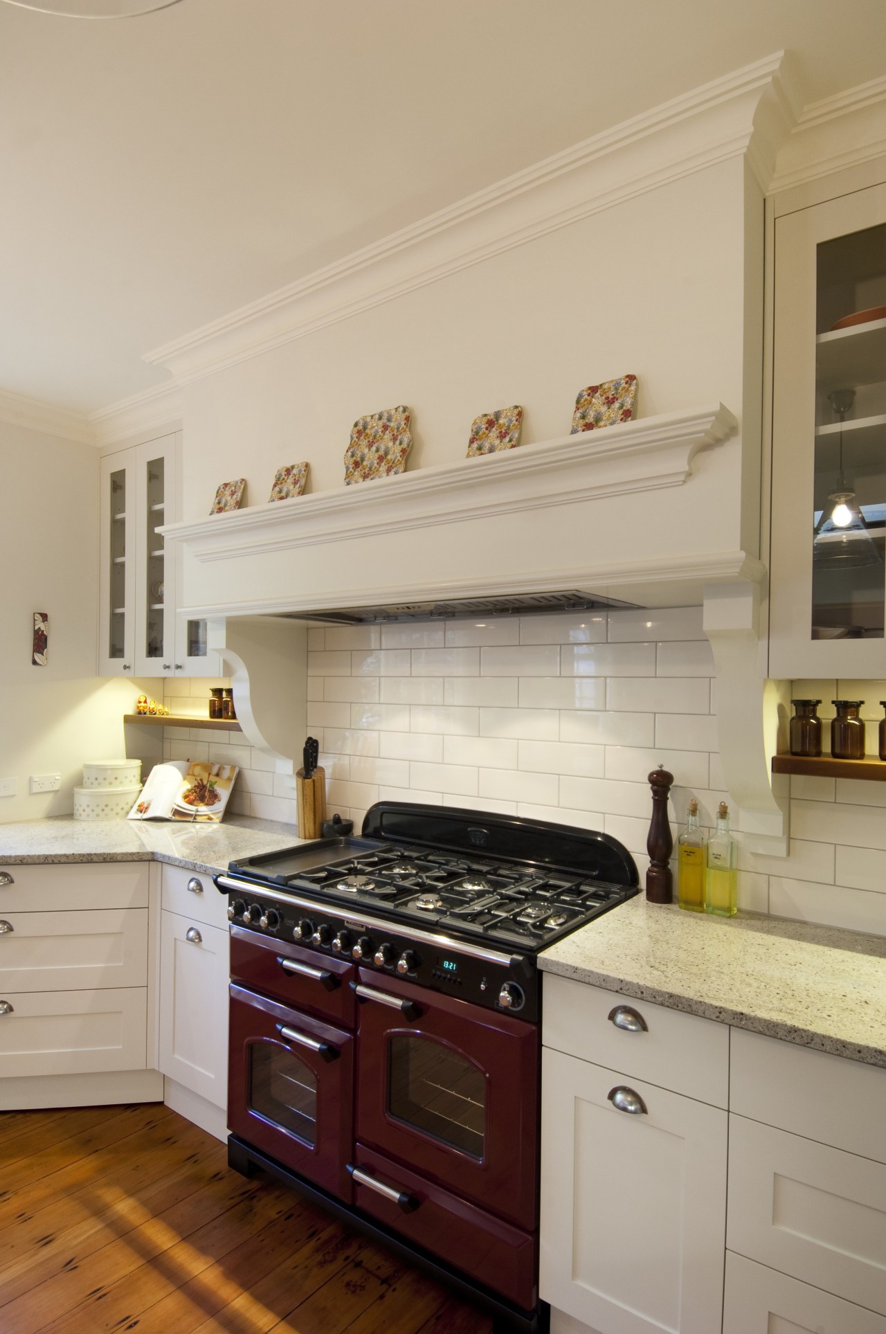 This kitchen was designed by Debra DeLorenzo of cabinetry, countertop, cuisine classique, floor, flooring, home appliance, interior design, kitchen, kitchen appliance, kitchen stove, room, orange