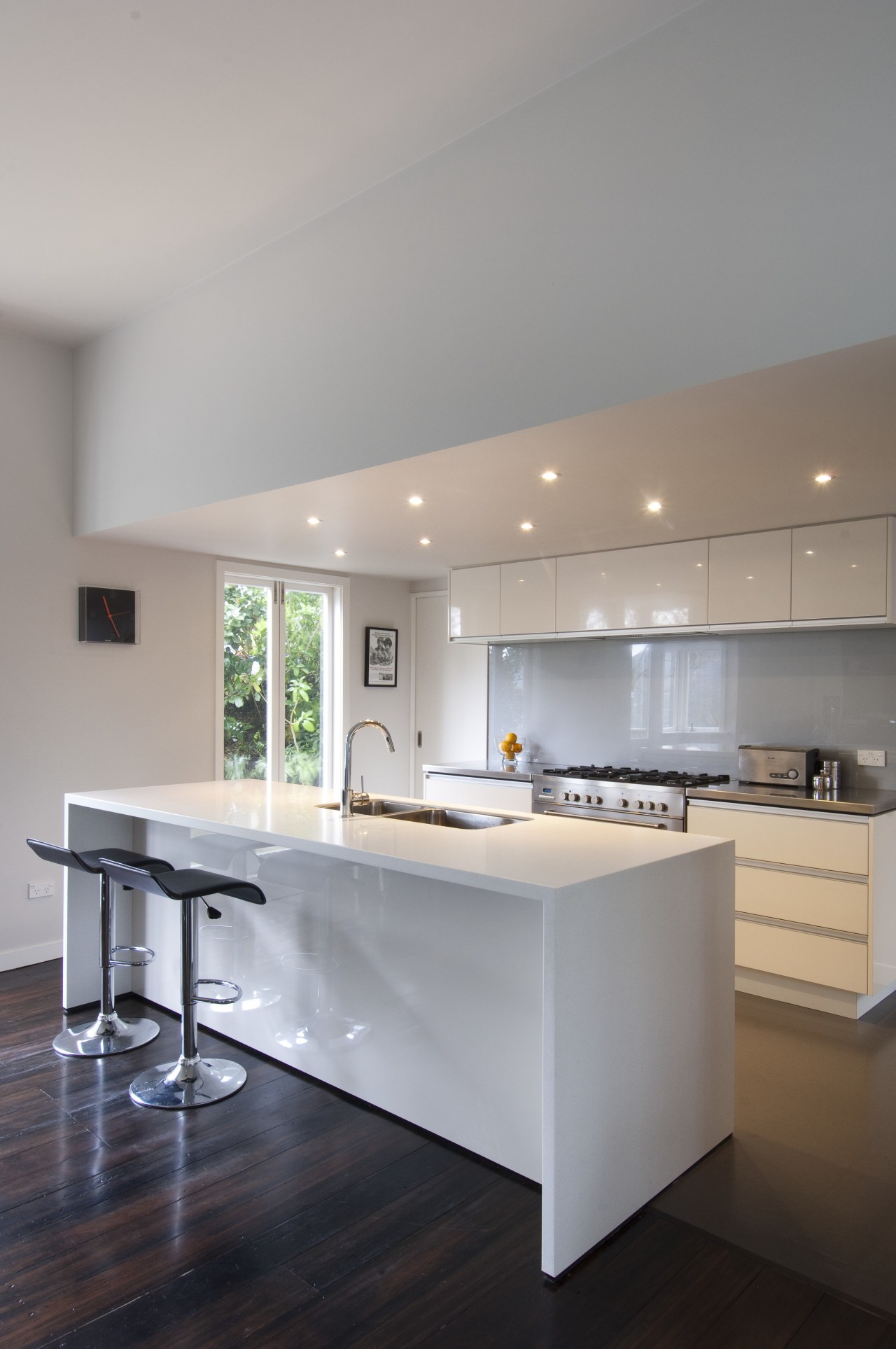 View fo kitchen. Wood floors and white cabinatry. architecture, cabinetry, ceiling, countertop, cuisine classique, daylighting, floor, flooring, hardwood, house, interior design, kitchen, laminate flooring, real estate, room, wood flooring, gray