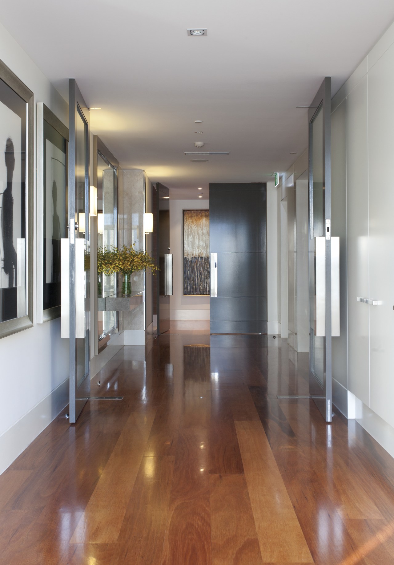 View of hallway with wooden flooring. apartment, ceiling, floor, flooring, hardwood, interior design, laminate flooring, lobby, real estate, wood, wood flooring, gray