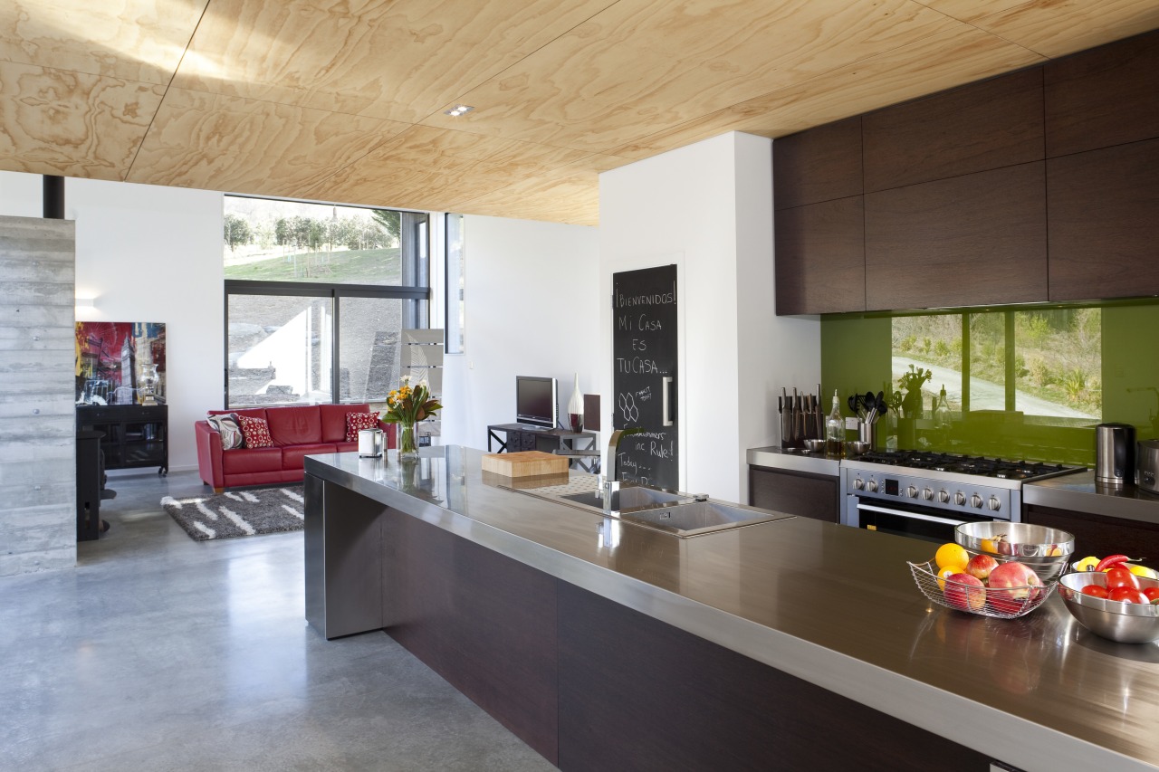 View of kitchen and lounge area. The owners architecture, countertop, house, interior design, kitchen, real estate, gray