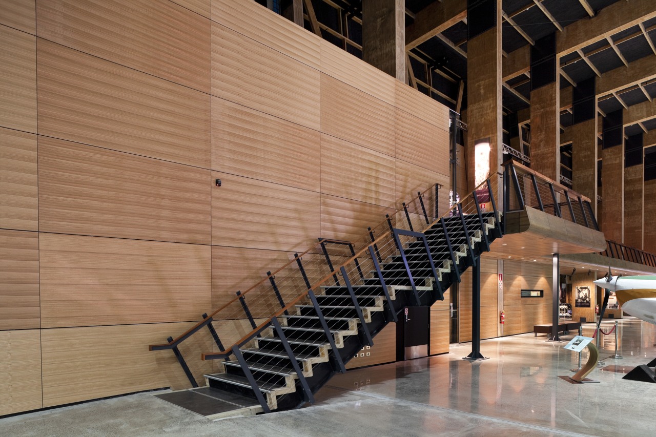 The acoustic timber panelling seen here in this architecture, handrail, stairs, structure, wall, wood, brown, orange