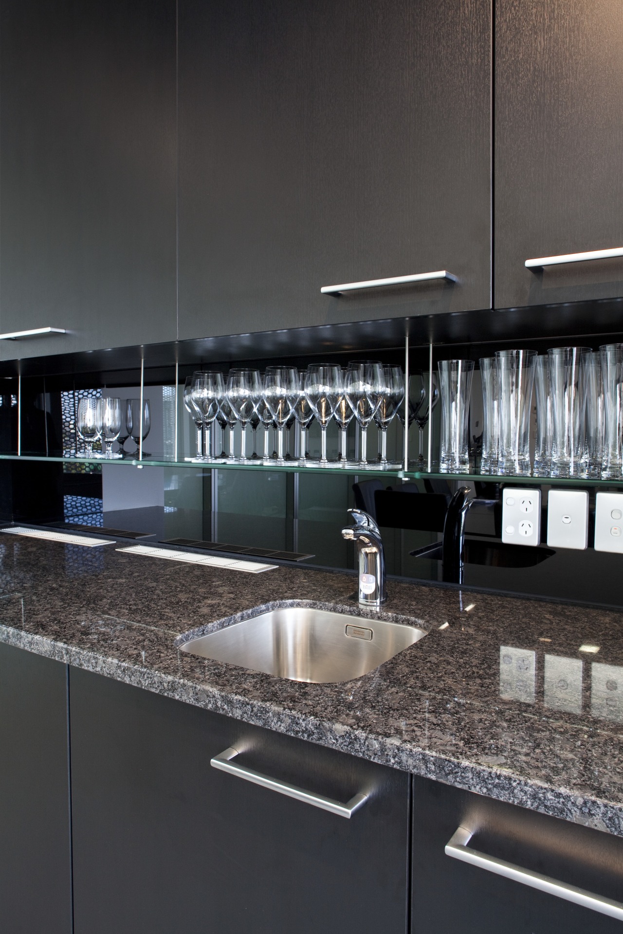 Seen here is a drinking-water system designed by countertop, glass, interior design, kitchen, lighting, under cabinet lighting, black