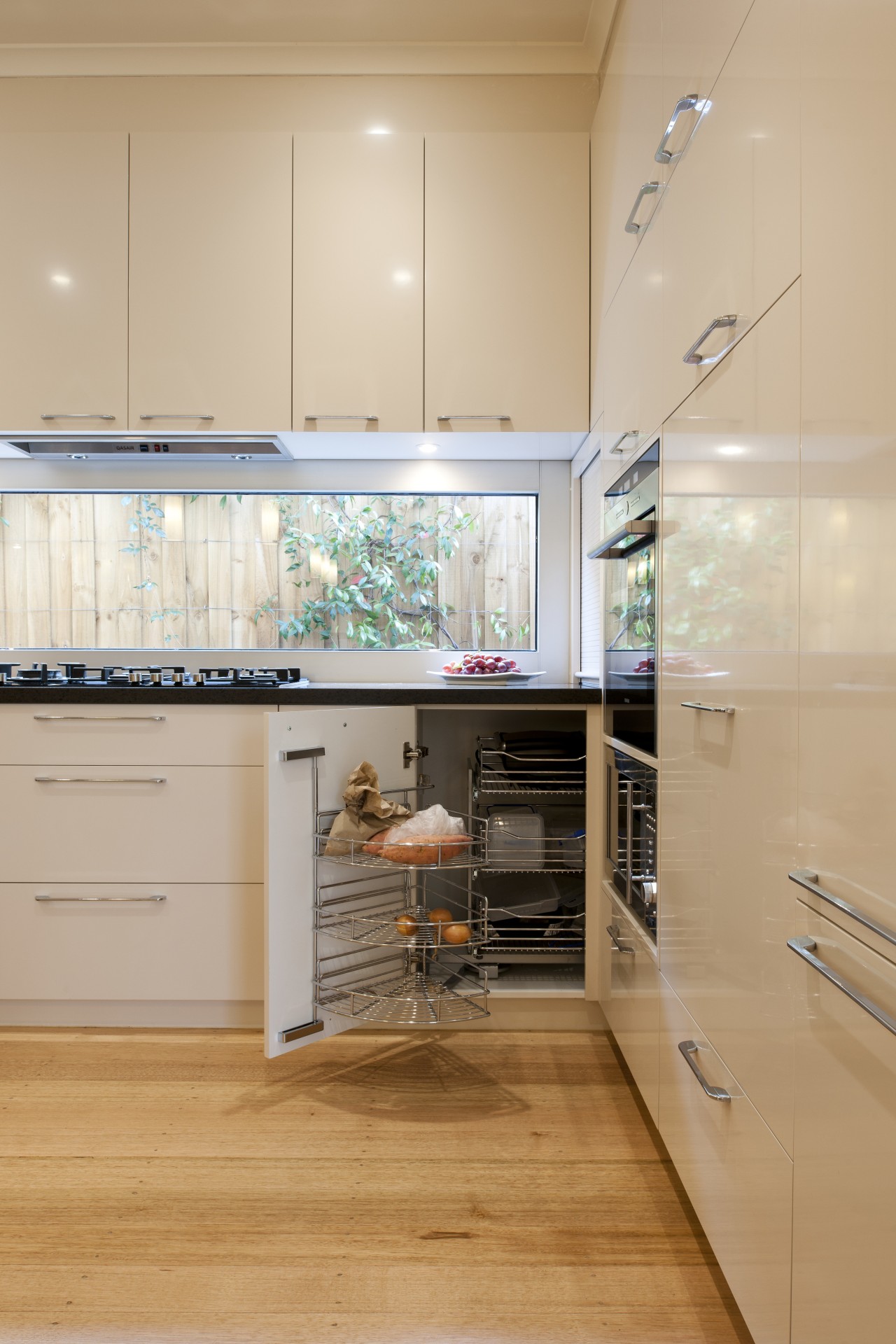 VIew of contemporary kitchen with wooden flooring and cabinetry, countertop, cuisine classique, floor, interior design, kitchen, room, orange