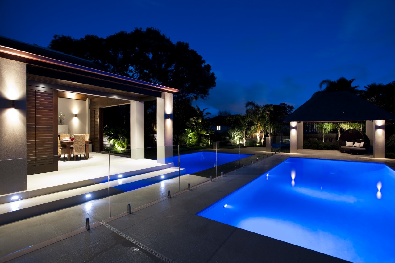 Outdoor night shot of contemporary house and pool architecture, backyard, estate, home, house, landscape lighting, leisure, lighting, property, real estate, resort, sky, swimming pool, villa, blue, black