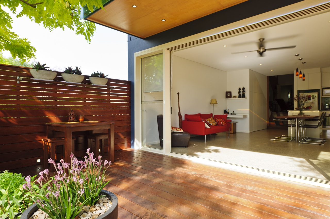 View of doorway from living room to patio. estate, floor, flooring, home, house, interior design, living room, property, real estate, orange