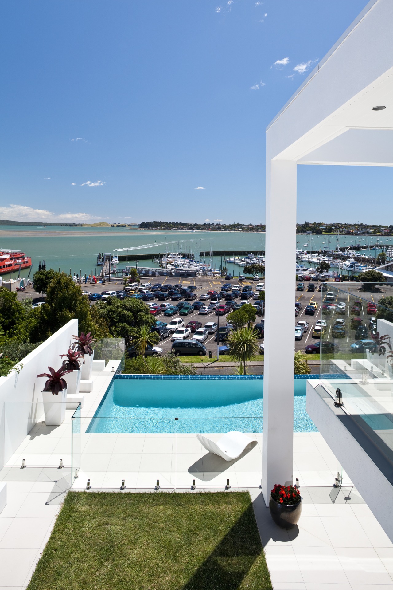 The pool beside this contemporary cliff-top house is condominium, hotel, leisure, real estate, resort, sea, sky, swimming pool, vacation, teal