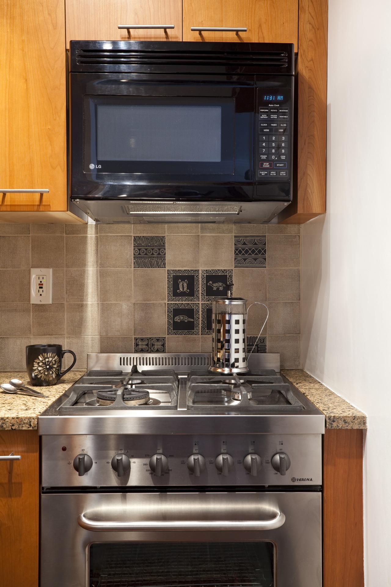 microwave above gas cooktop, partially integrated into cabinets cabinetry, countertop, flooring, gas stove, home, home appliance, kitchen, kitchen appliance, kitchen stove, major appliance, microwave oven, oven, room, under cabinet lighting, black