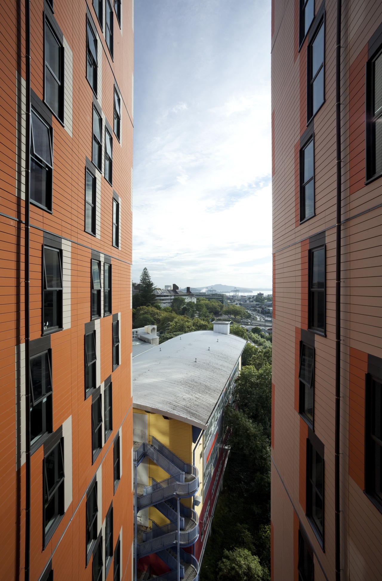 View of opposite facing exterior walls. apartment, architecture, balcony, building, city, condominium, facade, home, house, metropolitan area, mixed use, neighbourhood, real estate, residential area, sky, tower block, town, urban area, window, black